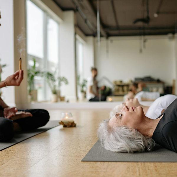 A group of diverse athletes sitting peacefully after a yoga session.