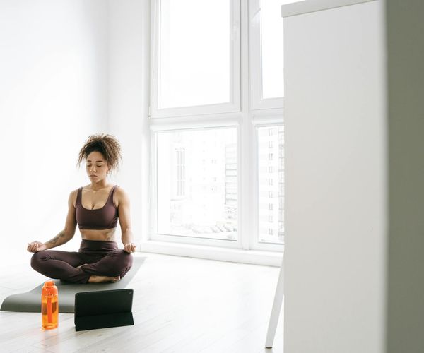 Yoga mat, water bottle, and comfortable clothes ready for a session.